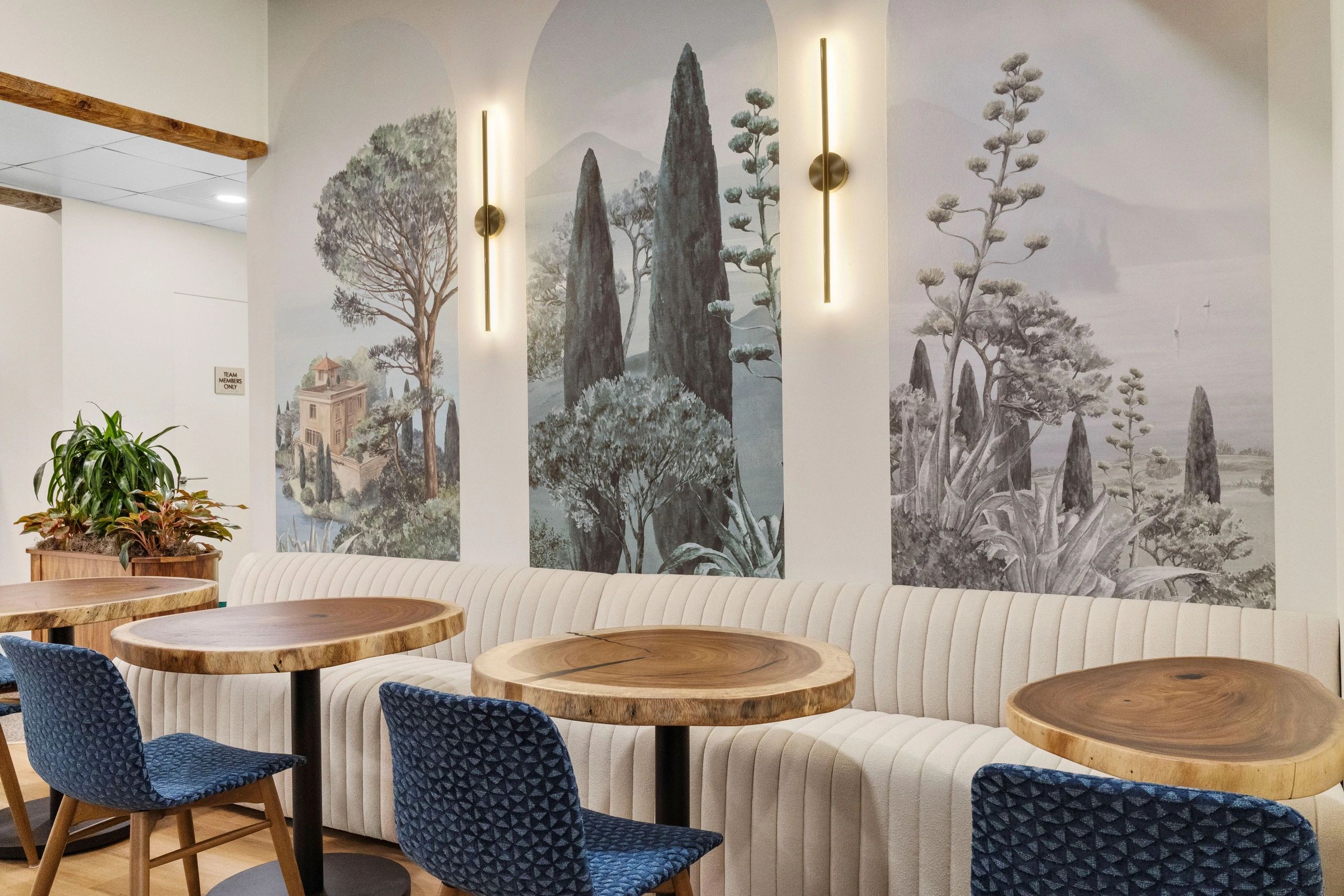 Modern restaurant interior with blue ceiling and marble bar counter.